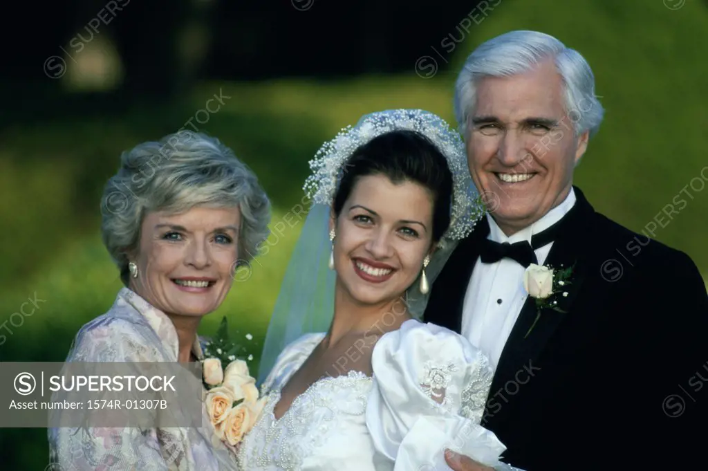Portrait of a bride standing with her parents