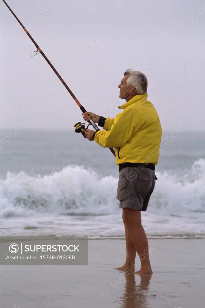 Senior man fishing on the beach