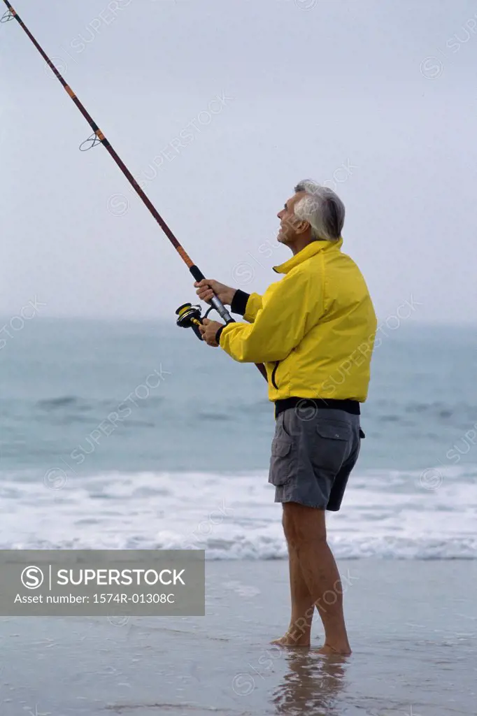 Senior man fishing at the beach