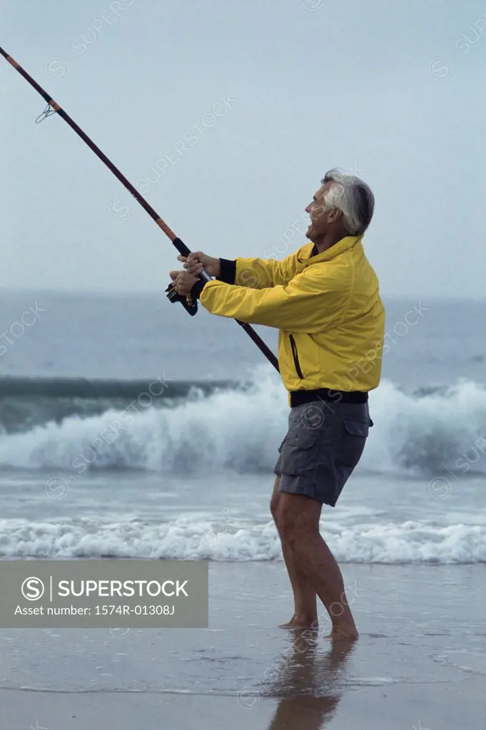 Side profile of a senior man fishing at the beach