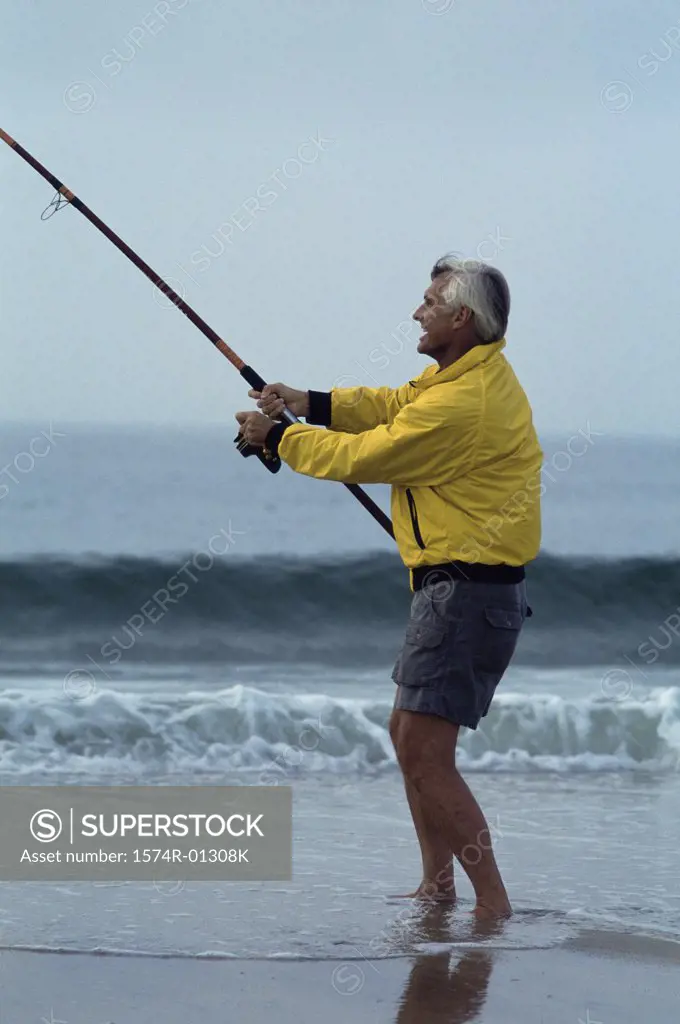 Senior man fishing at the beach
