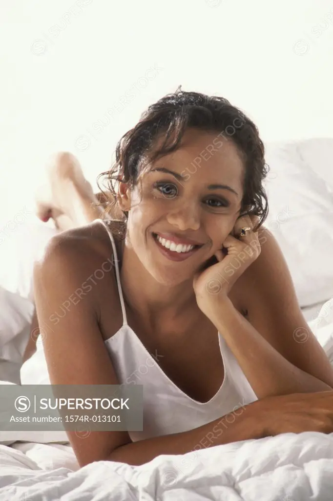 Portrait of a young woman lying in bed