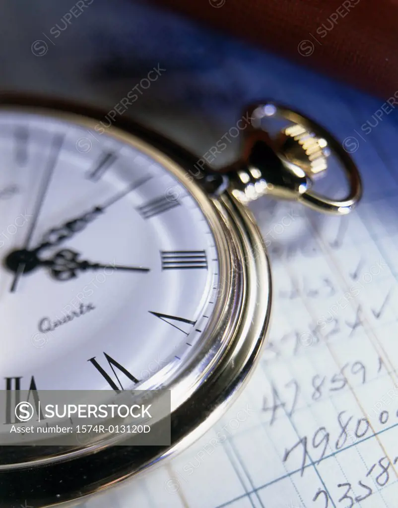 Close-up of a stopwatch on sheets of paper