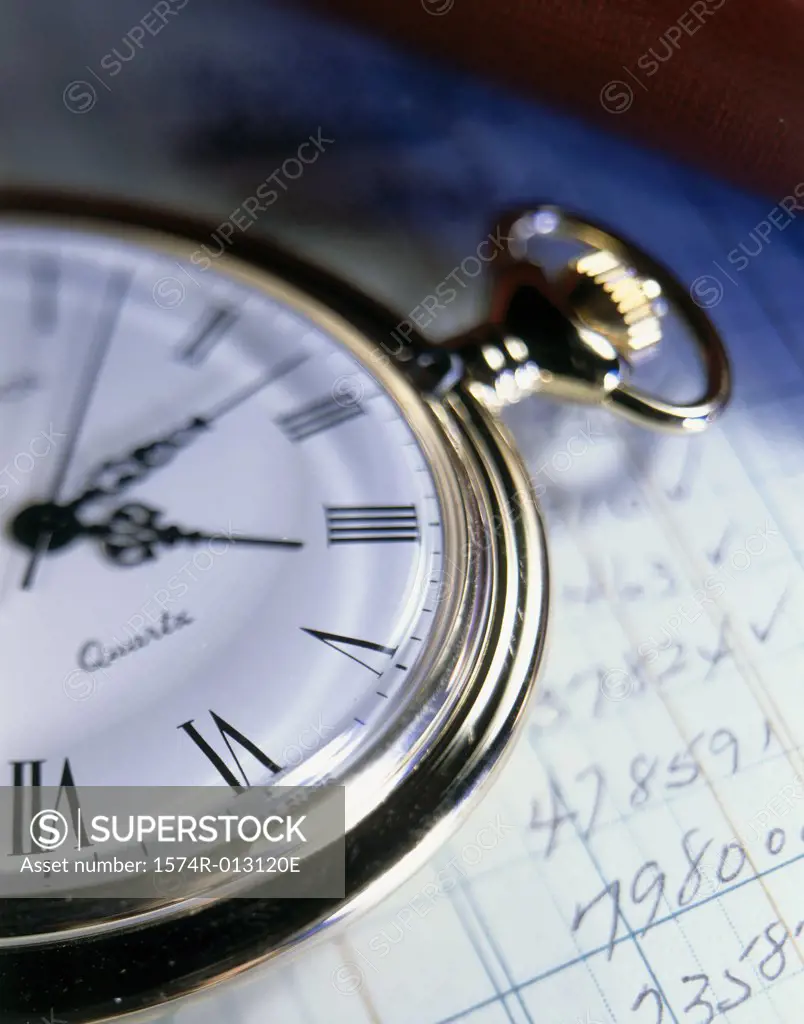 Close-up of a stopwatch on sheets of paper