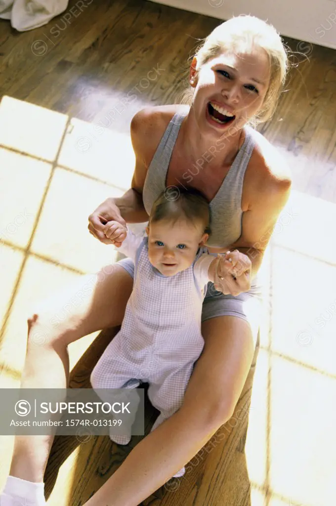 Portrait of a mother holding her son laughing