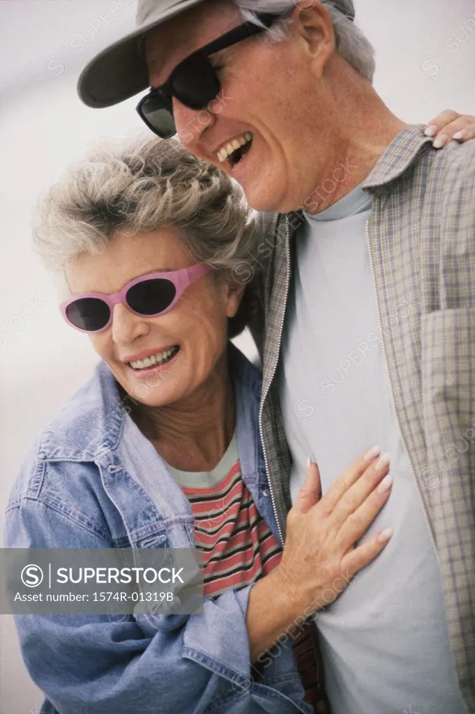 Senior couple standing together laughing