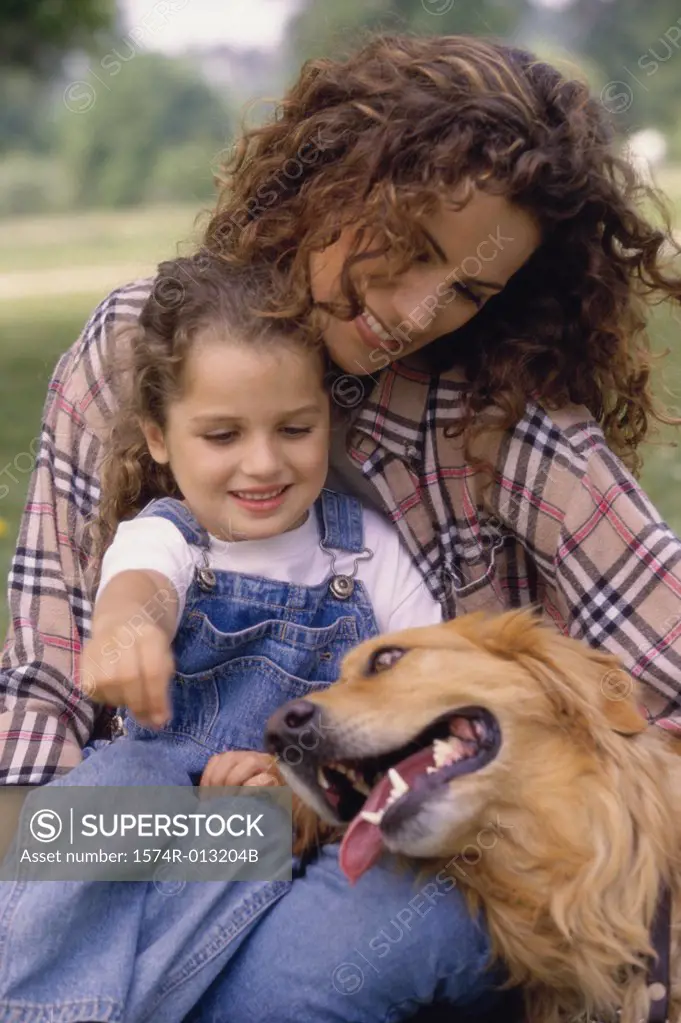 Mother and daughter sitting with a dog