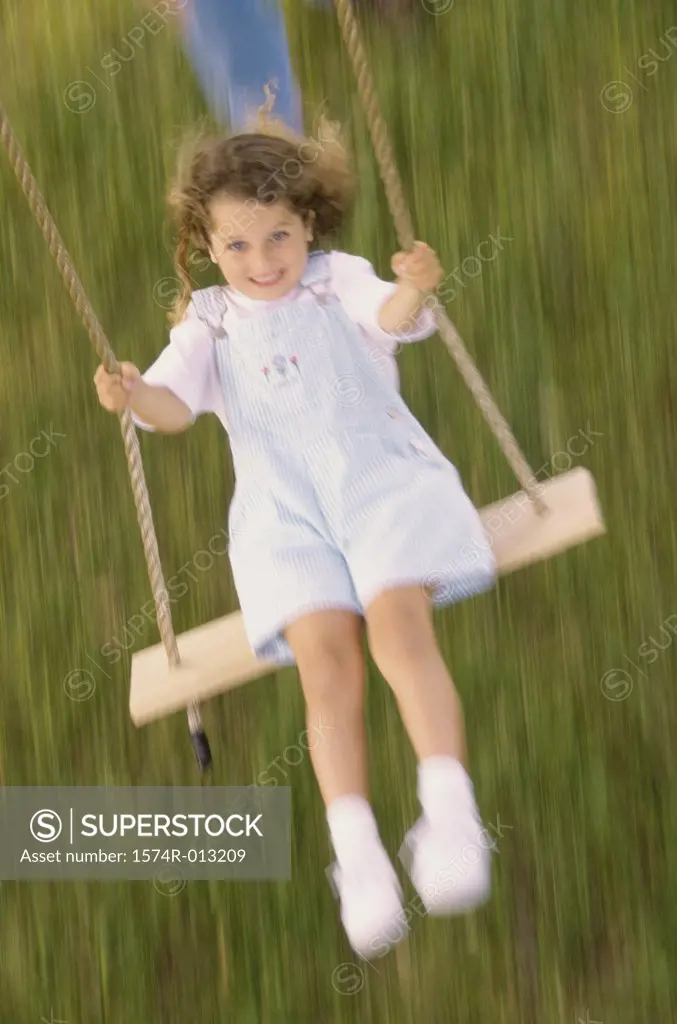 High angle view of a girl swinging on a swing