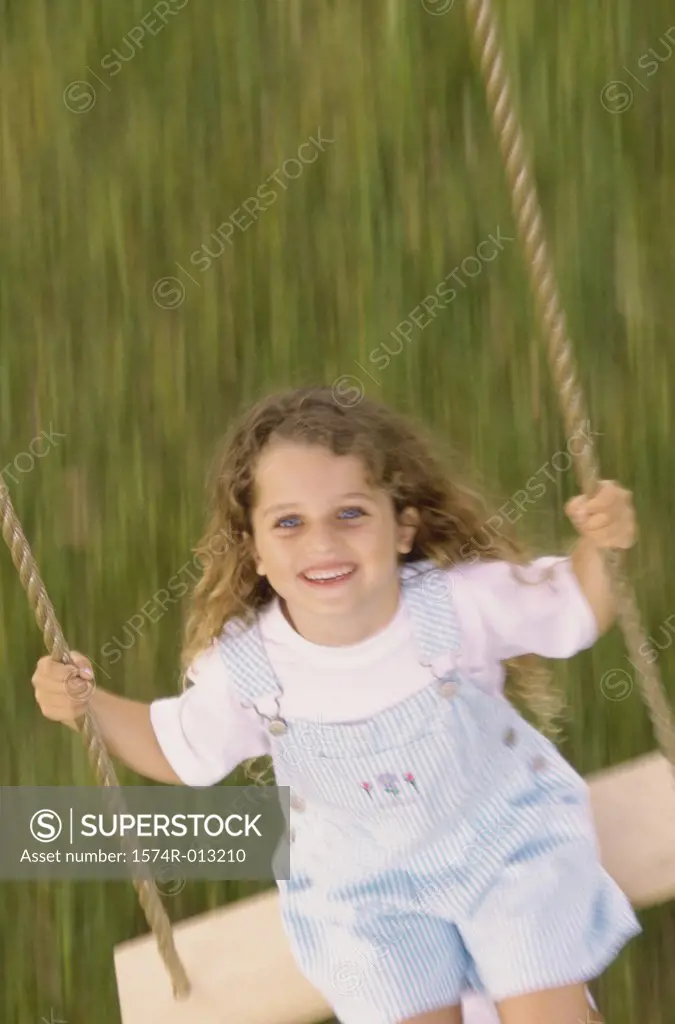 High angle view of a girl swinging on a swing