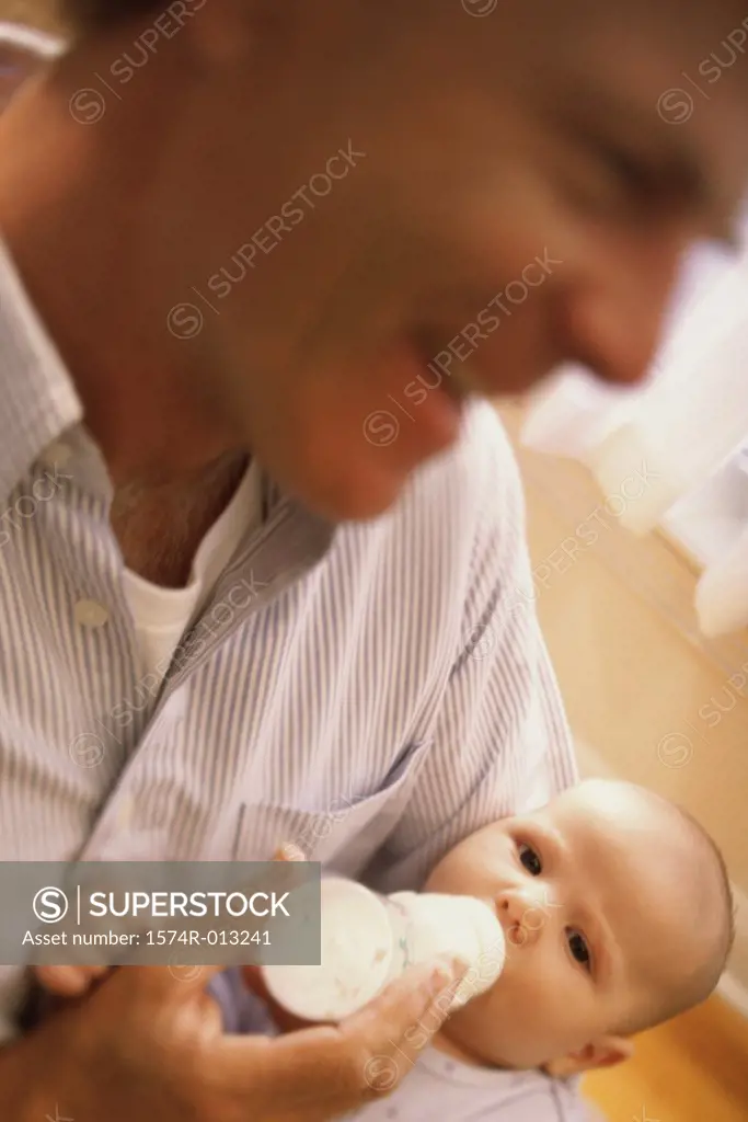 Close-up of a father feeding his daughter
