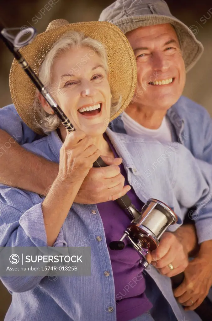 Portrait of a senior couple holding a fishing rod