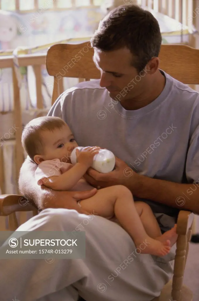 Father feeding his daughter