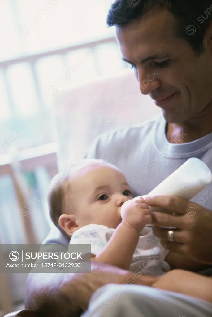 Close-up of a father feeding his son