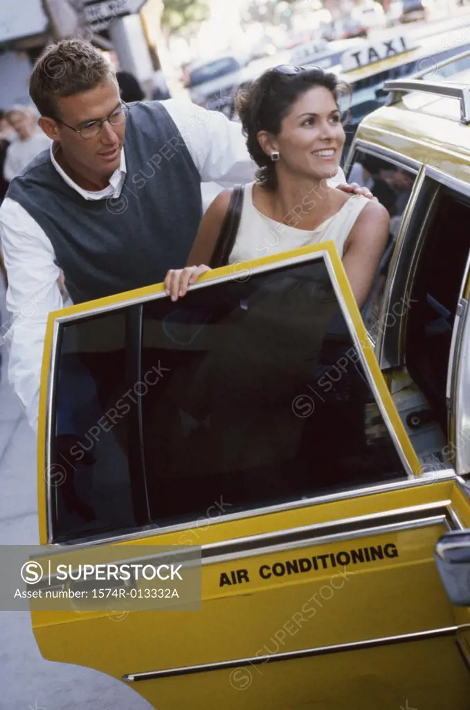 Mature couple entering a taxi