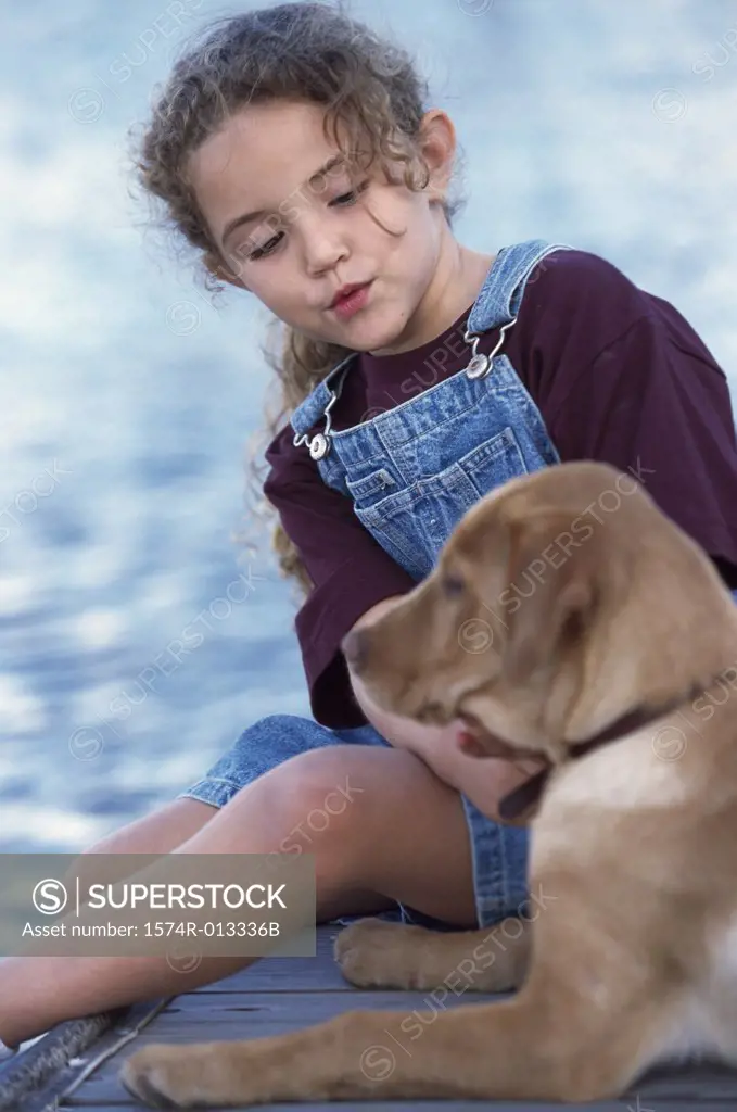 Close-up of a girl sitting with her dog