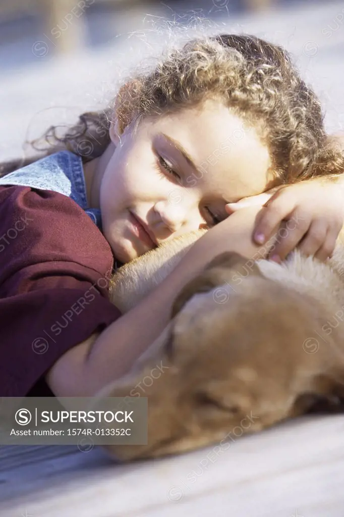 Close-up of a girl sleeping with her dog
