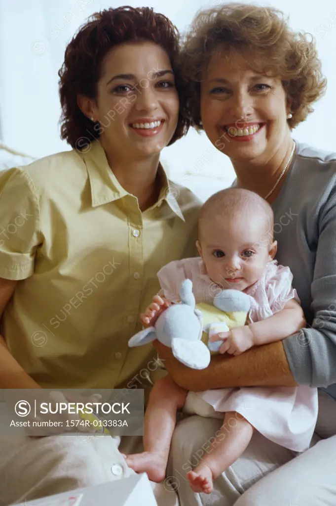 Portrait of a grandmother smiling with her daughter and granddaughter