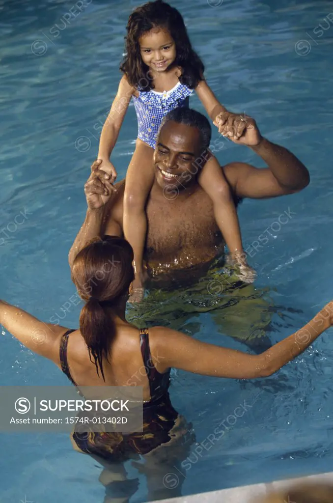 High angle view of parents with their daughter in a swimming pool