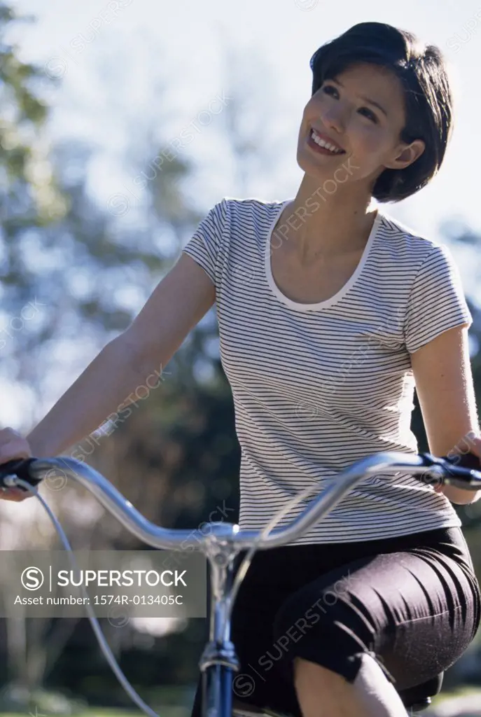 Close-up of a young woman cycling