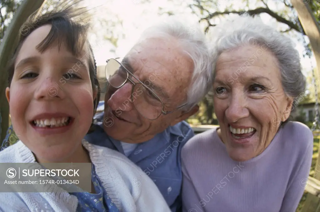 Portrait of a granddaughter smiling with her grandparents