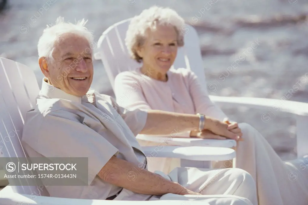 Side profile of a senior couple sitting on the beach