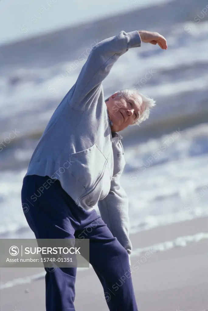 Senior man exercising at the beach