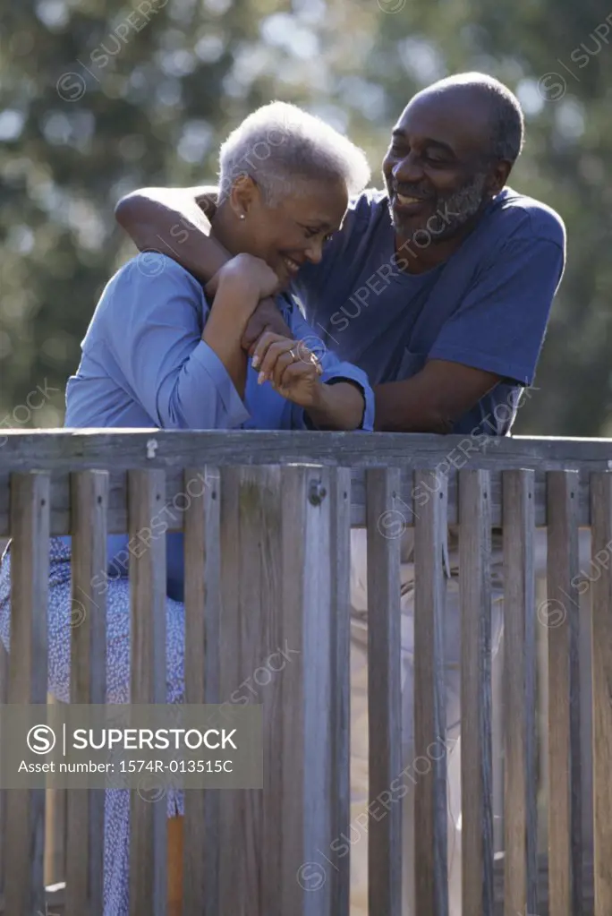 Senior couple leaning against a railing