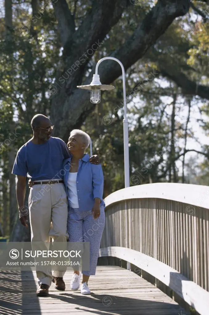 Senior couple walking on a bridge