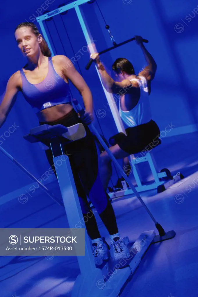 Young woman and a young man exercising in a gym