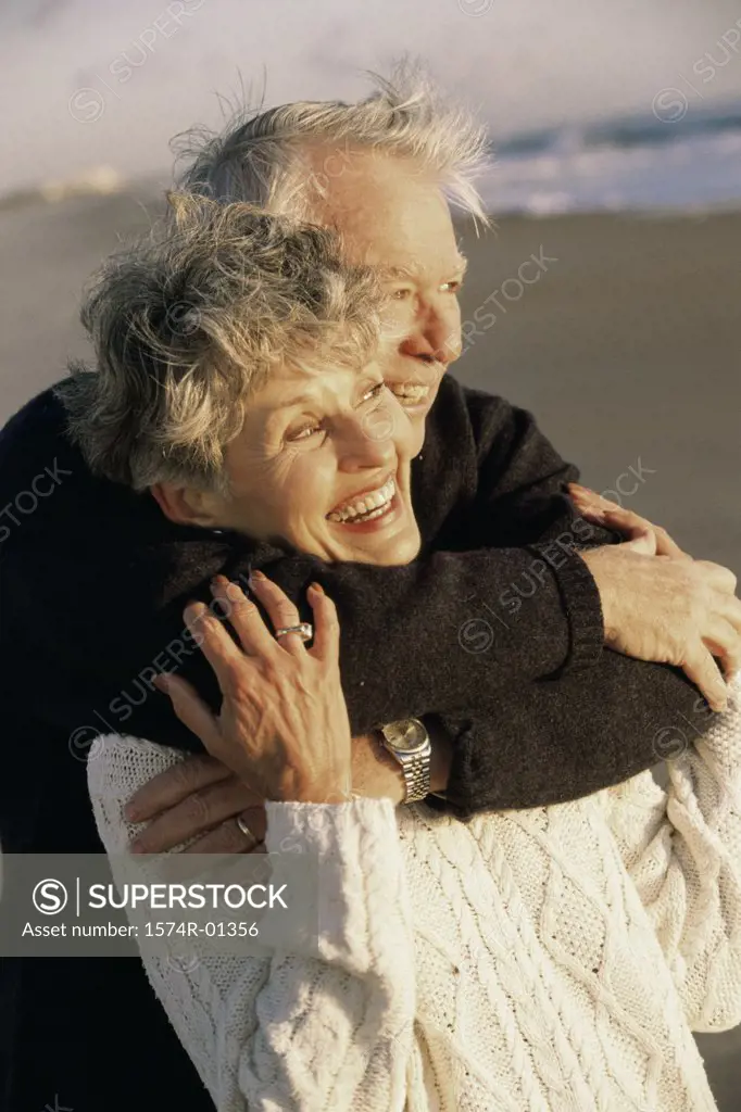 Senior couple holding each other at the beach