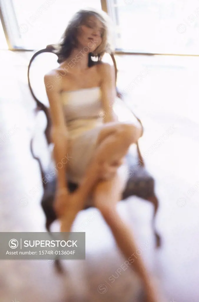 High angle view of a young woman relaxing in a chair