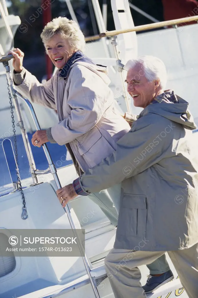 Side profile of senior couple stepping on a boat
