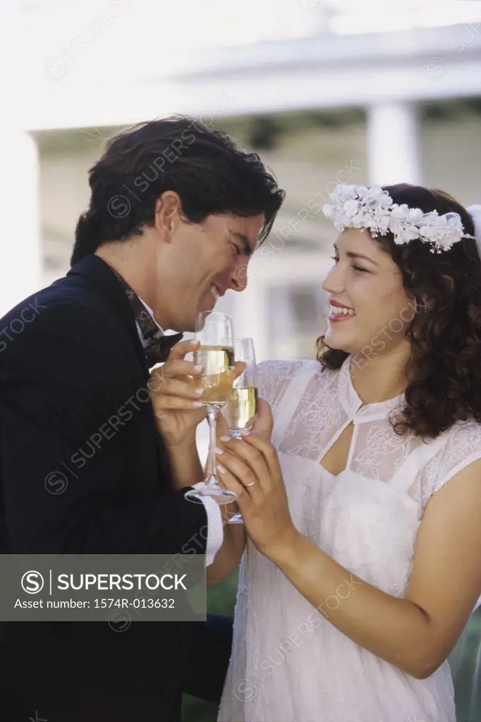 Close-up of a newlywed couple toasting with champagne