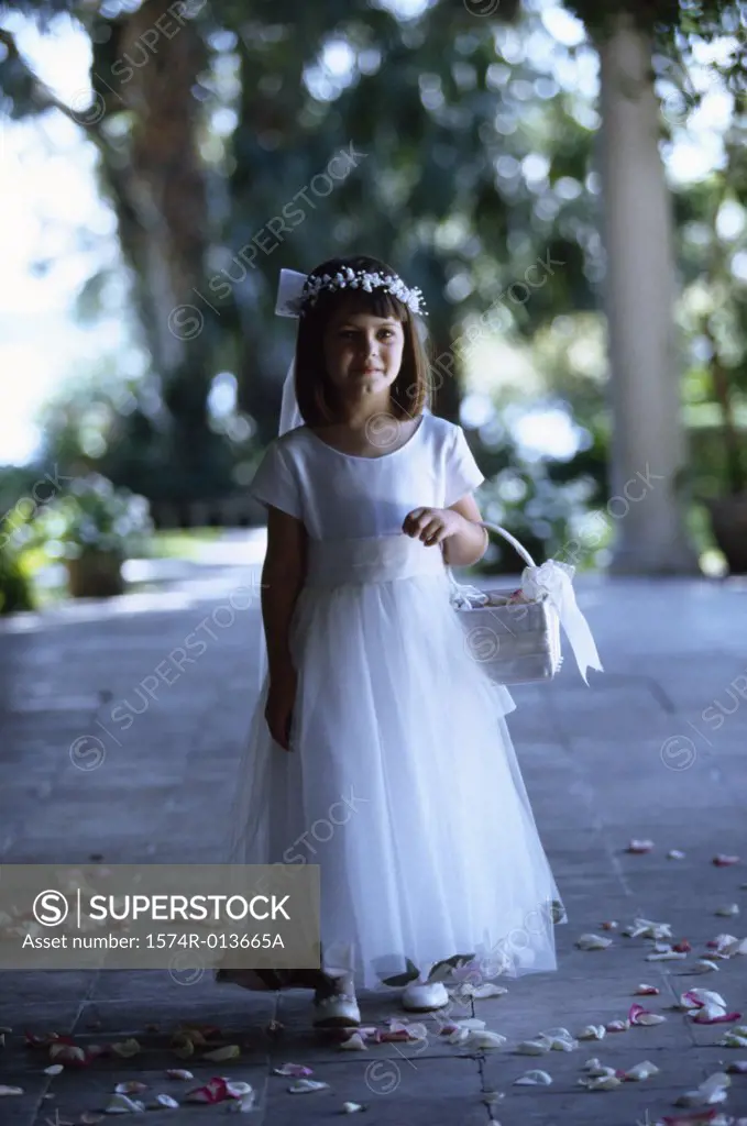 Flower girl walking with a flower basket