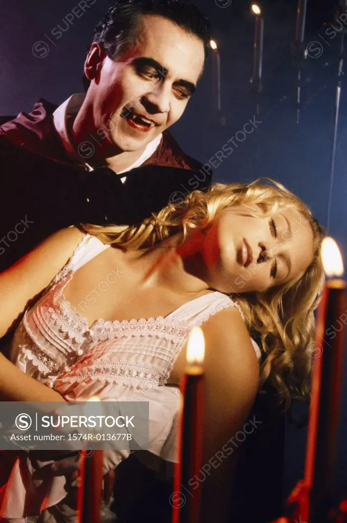 Close-up of a vampire carrying an unconscious young woman