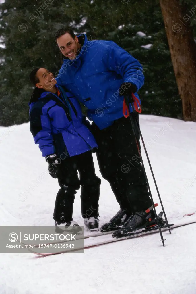 Portrait of a father and son standing in snow