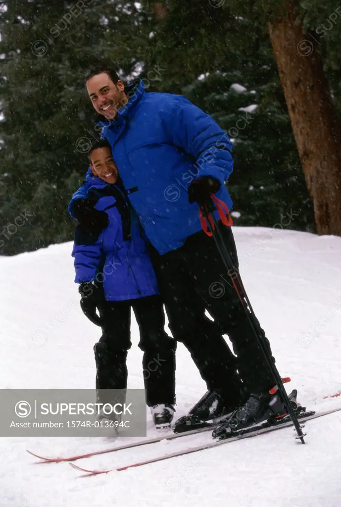 Portrait of a father and son standing in snow
