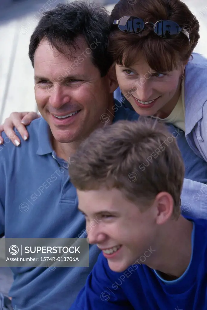 Close-up of parents and their son smiling