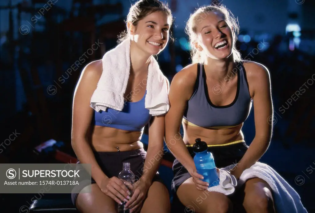 Close-up of two young women smiling in a gym