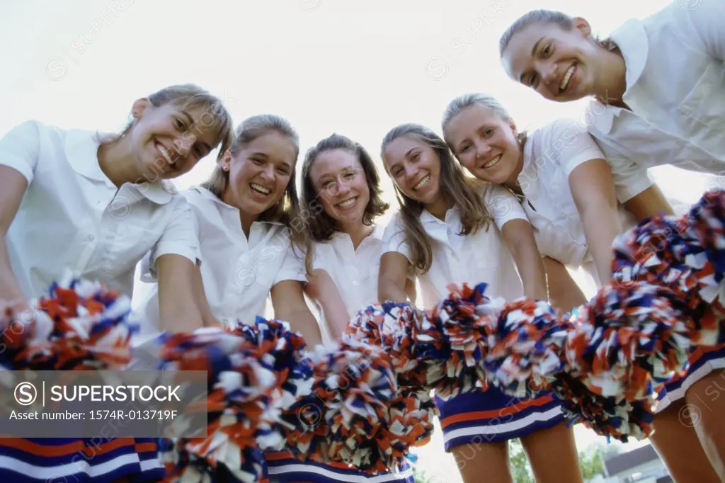 Portrait of a group of cheerleaders holding pom-poms