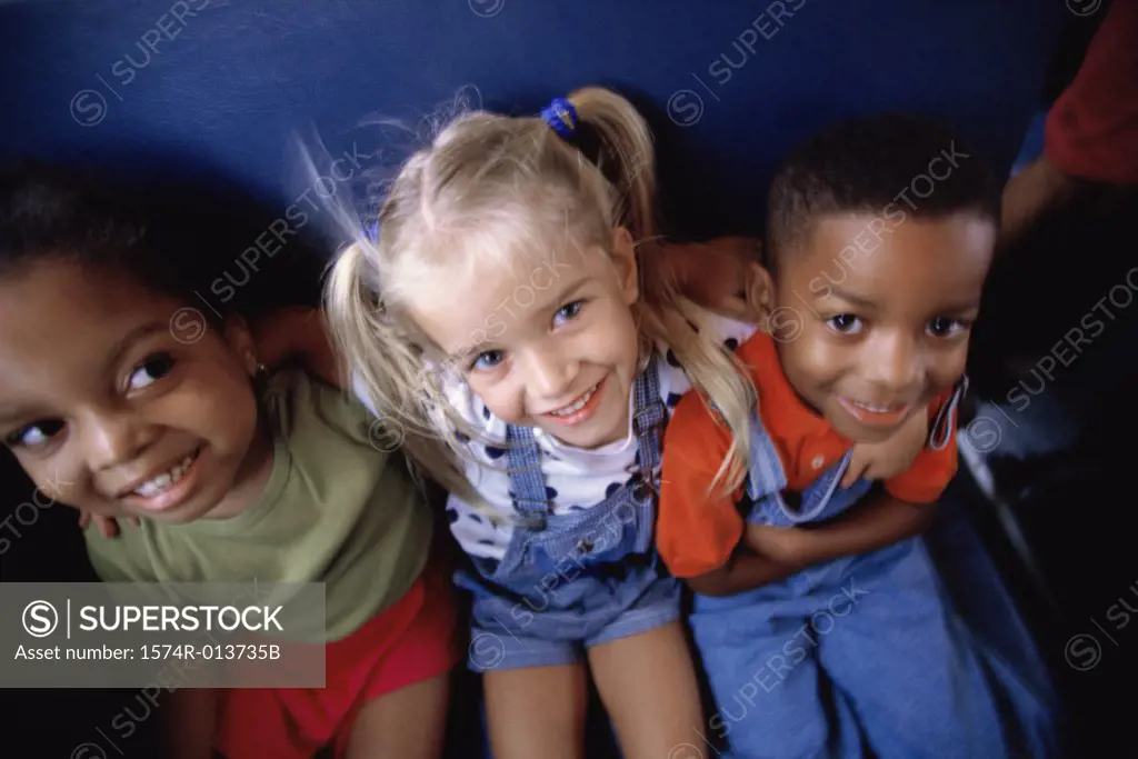 Portrait of a boy and two girls smiling
