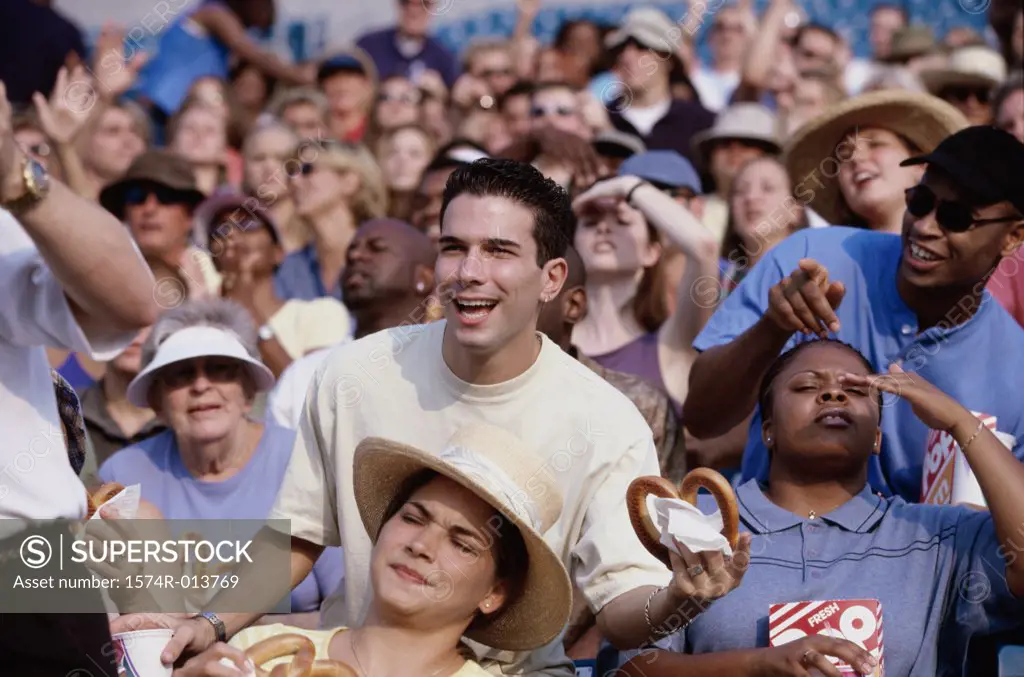 Spectators in a stadium eating pretzels