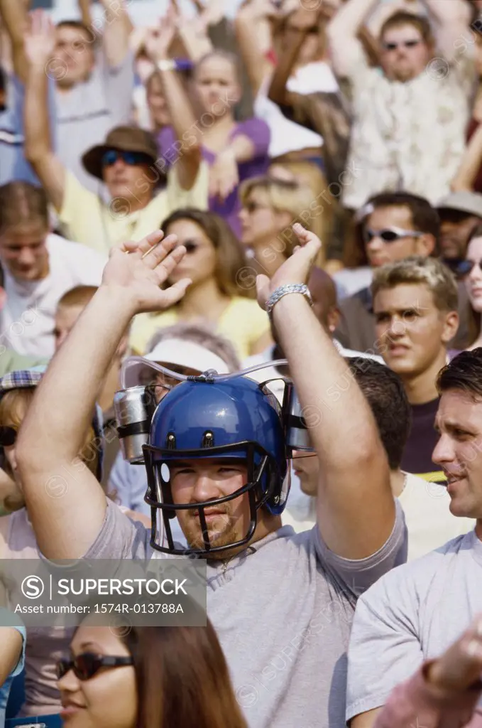 Spectator wearing a football helmet and cheering