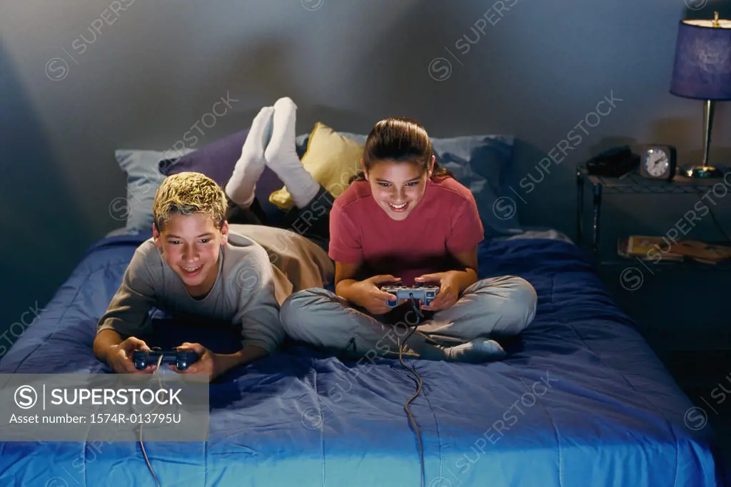 High angle view of a brother and sister playing video games