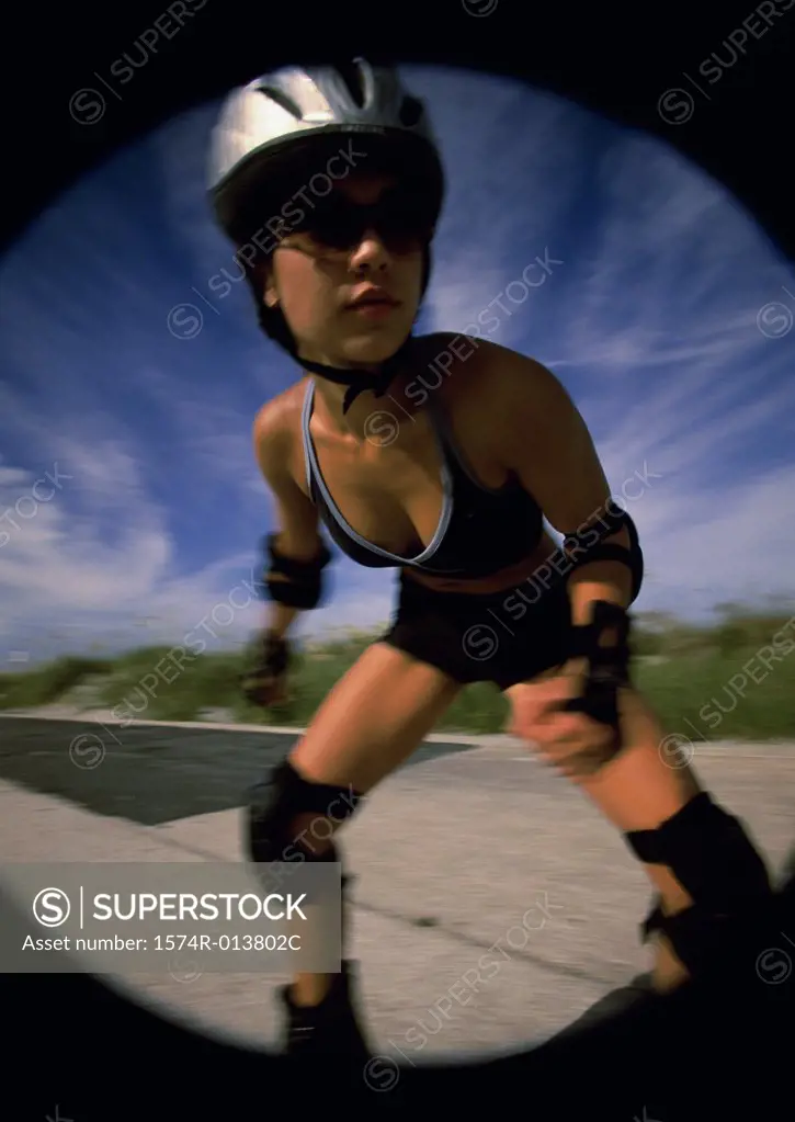 Young woman inline skating on a road