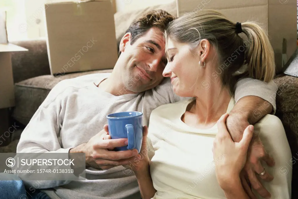 Close-up of a young couple holding a cup of coffee