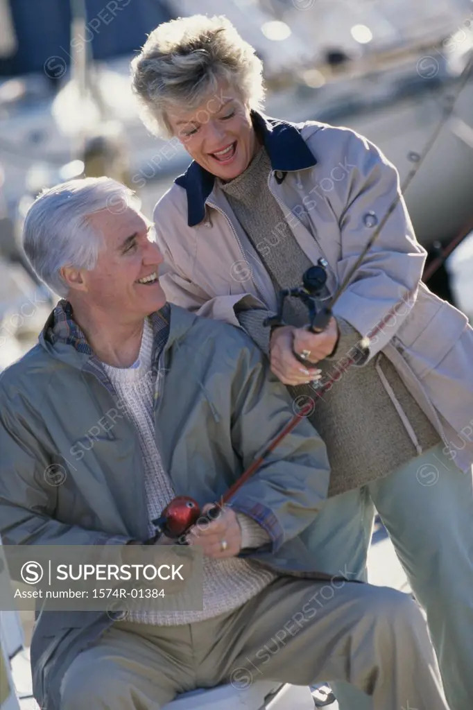 Senior couple fishing holding fishing rods