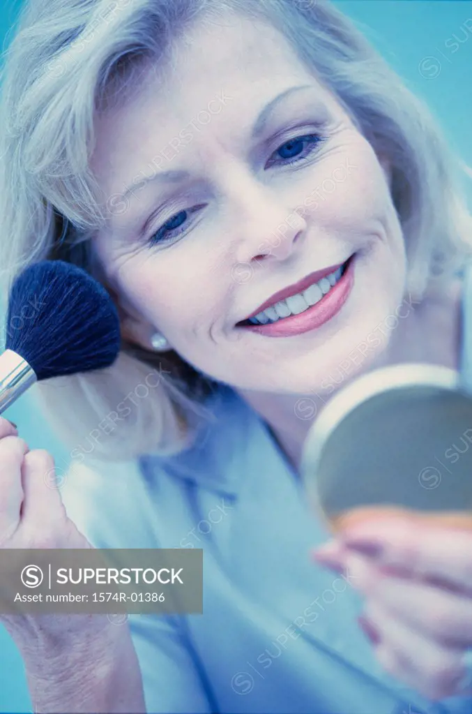 Close-up of a woman applying make-up