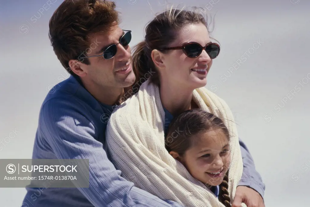 Close-up of parents and their daughter smiling