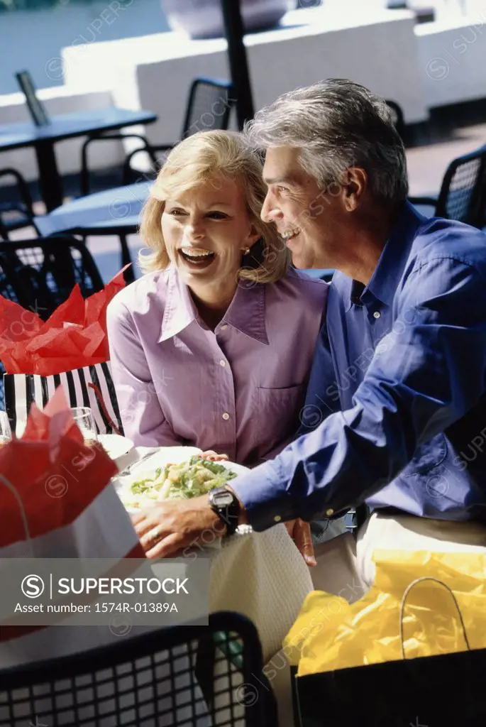 Mid adult couple sitting together smiling